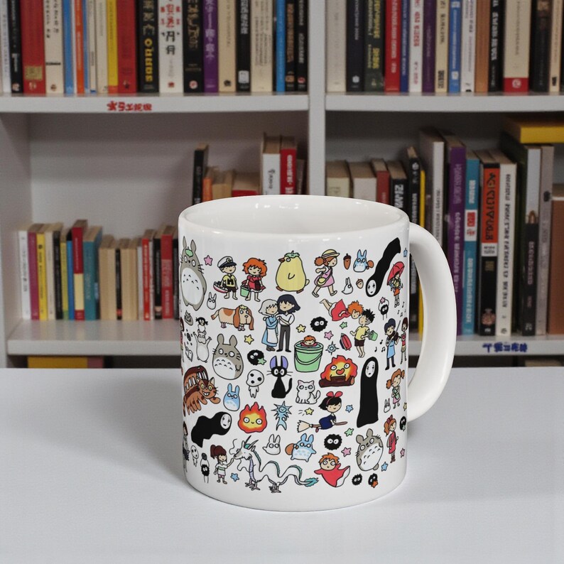 Anime aesthetic desk setup featuring a cute forest spirit coffee mug inspired by the whimsical animation style of Studio Ghibli and magical films like Spirited Away.
