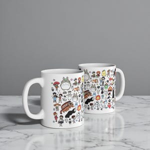 Ceramic coffee mug with adorable Kodama and forest spirit illustration inspired by the fantasy worlds of Princess Mononoke and My Neighbor Totoro.