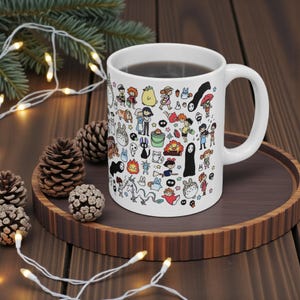 Side angle of a ceramic anime mug with adorable Kodama forest spirit illustration inspired by Studio Ghibli fantasy worlds and iconic movies like Spirited Away.