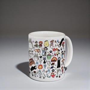 Cute kawaii anime mug featuring nature spirit characters inspired by Studio Ghibli aesthetic. Whimsical coffee cup design reminiscent of Spirited Away and forest spirit themes.