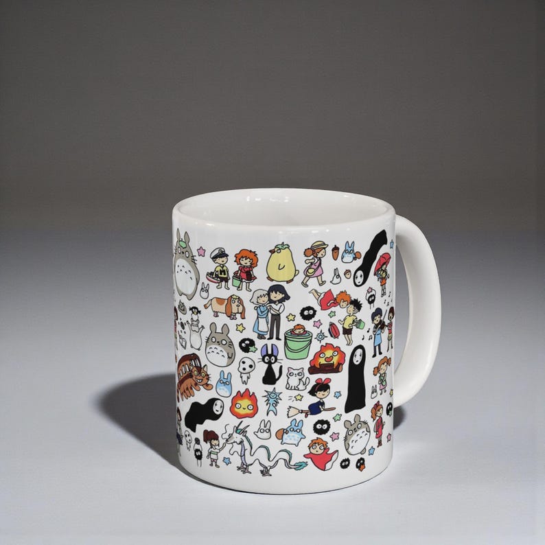 Cute kawaii anime mug featuring nature spirit characters inspired by Studio Ghibli aesthetic. Whimsical coffee cup design reminiscent of Spirited Away and forest spirit themes.