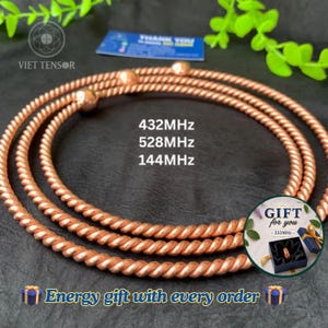 May include: Three circular copper-colored wire coils with a twisted texture. The coils are labeled with the text 432MHz, 528MHz, and 144MHz. A small circular inset shows a gift box with the text GIFT for you 333MHz. Text reads Energy gift with every order.