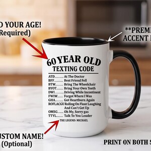 May include: White ceramic mug with a black interior and handle. The mug features the text "60 YEAR OLD TEXTING CODE" with a list of acronyms and their meanings. The text "THE LEGEND: MICHAEL" is also printed on the mug.