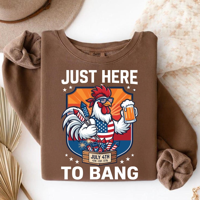 Humorous American flag rooster graphic printed on a cozy oversized Comfort Colors sweatshirt.