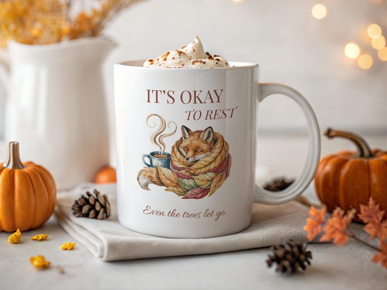Cozy fox autumn mug in high-quality white ceramic, perfect for coffee, tea, or hot chocolate. Illustrated fox surrounded by autumn leaves, cottagecore and hygge style. A thoughtful gift for women or men, animal lovers, and woodland enthusiasts. Unique illustrated mug, durable, dishwasher and microwave safe, perfect for cozy fall vibes or as a seasonal gift idea for fox lovers and autumn home décor.