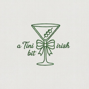 May include: Green embroidered design of a martini glass with olives, a bow, and the text "a Tini bit irish" on a white background. The martini glass is the focal point, with a bow at the base and the text in a cursive font.