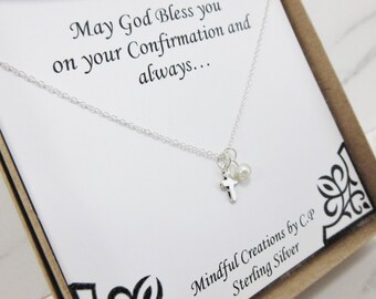 May include: A silver necklace with a small cross charm and a pearl bead. The necklace comes in a box with a card that reads "May God Bless you on your Confirmation and always... Mindful Creations by C.P Sterling Silver".
