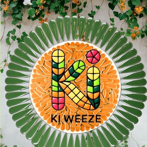 May include: A colorful logo with the text "KI WEEZE" in a vibrant design. The logo features a large "K" composed of various geometric shapes in yellow, green, and red. The logo is surrounded by green leaf-shaped elements and orange shapes.