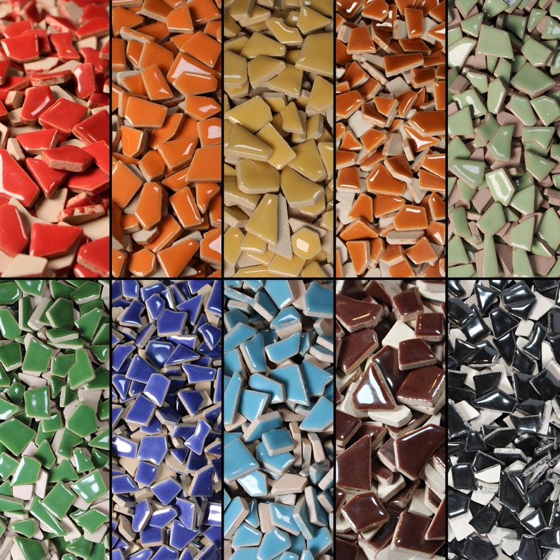 May include: A collage of colorful, broken ceramic tiles in various shades. The tiles are arranged in vertical columns, showcasing a range of colors including red, orange, yellow, brown, green, blue, and black. The broken pieces vary in size and shape.