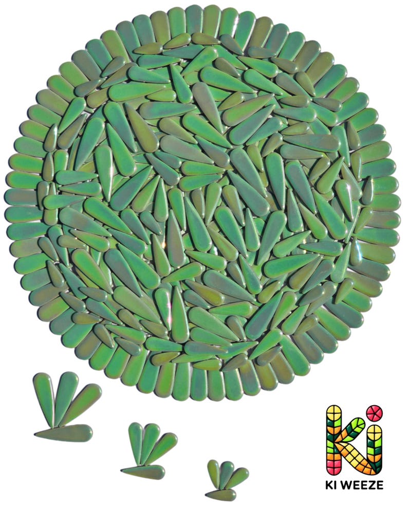 May include: A round, green decorative piece composed of numerous teardrop-shaped elements. The elements are arranged in a circular pattern, with a border of similar shapes. The piece has a glossy finish and varying shades of green. The logo "KI WEEZE" is in the bottom right corner.