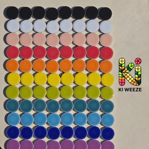 May include: A grid of colorful, round ceramic tiles arranged in rows. The colors transition from black to white, then through shades of pink, red, orange, yellow, green, blue, and purple. The text "KI WEEZE" is in the lower right corner.