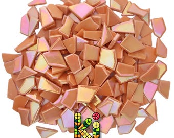 May include: A collection of small, irregular peach-colored glass mosaic tiles with an iridescent finish. The pieces vary in shape and size, featuring a smooth, reflective surface. The logo for KI WEEZE is visible at the bottom center.