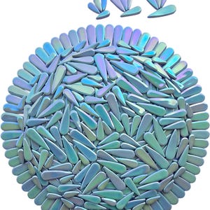 May include: A circular arrangement of iridescent, teardrop-shaped objects in shades of blue, green, and purple. The objects are arranged in a dense pattern, with a few similar shapes above the circle. The overall effect is a shimmering, abstract design.