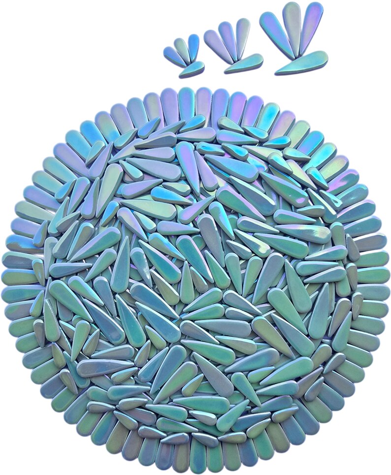 May include: A circular arrangement of iridescent, teardrop-shaped objects in shades of blue, green, and purple. The objects are arranged in a dense pattern, with a few similar shapes above the circle. The overall effect is a shimmering, abstract design.
