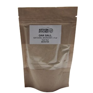 May include: A brown paper bag with a clear window showing a light brown powder inside. The bag has a white label that says "Sustainable Stitches" and "Oak Gall Natural Mordant, 4 oz Gall Nut MORD100".