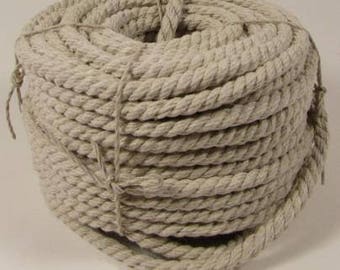 May include: A large, tightly wound coil of thick, natural beige rope made of twisted fibers. The rope is secured with thinner twine tied in several places around the circumference to maintain its circular, bundled shape and structure.