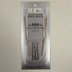May include: A pair of 26 inch, size 2 (2.75 mm) bamboo knitting needles in a clear plastic package. The package has the text "Crystal Palace Bamboo Needles" and "Crystal Palace Yarns" printed on it.