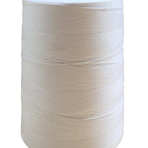 May include: A spool of white cotton thread.
