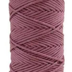 May include: A spool of pink cotton cord, ideal for crafting projects.