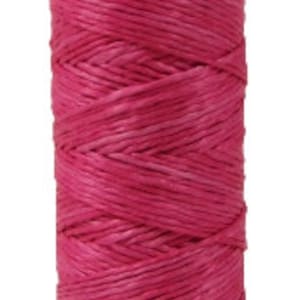 May include: A spool of pink waxed linen thread, wound on a wooden bobbin.