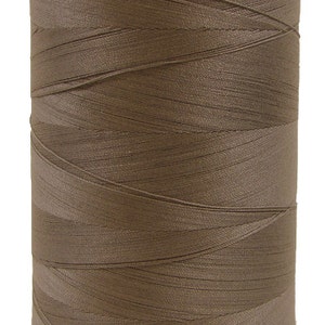 May include: A spool of brown thread.