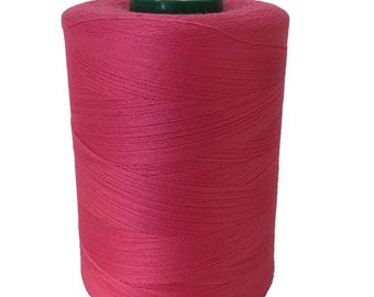 May include: A spool of pink thread.