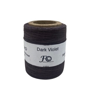 May include: A spool of dark violet waxed thread for hand sewing. The label reads "Dark Violet" and "Hand Sewing Thread".