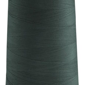 May include: A spool of dark green thread.