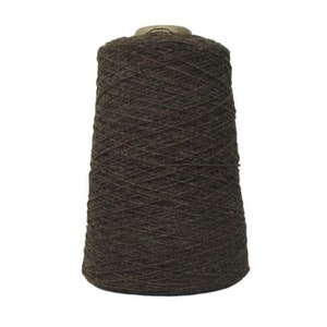 May include: A brown skein of yarn wound on a cardboard spool.