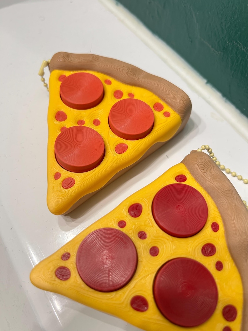 Juguete antiestrés con clicker y forma de rebanada de pizza imagen 2