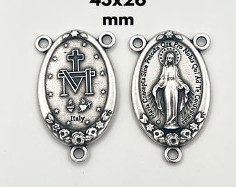 May include: Two silver-colored oval rosary centerpieces, each measuring 43x26 mm. One features a cross and the letter M, with the word "Italy" below. The other depicts a religious figure with text around the border.