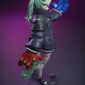 May include: A figurine of a character with green hair, red eyes, and a black outfit with white accents. The figure is holding a blue hand up and a red and green weapon. The figure is standing on a black base with a purple background.