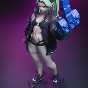May include: A detailed figurine of a female character with pale skin, green hair, and red eyes. She wears a black jacket, shorts, and a bra, with a blue robotic arm. The figure stands on a dark platform with a futuristic design. The overall theme is science fiction.