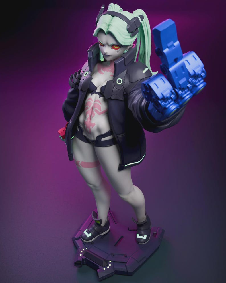 May include: A detailed figurine of a female character with pale skin, green hair, and red eyes. She wears a black jacket, shorts, and a bra, with a blue robotic arm. The figure stands on a dark platform with a futuristic design. The overall theme is science fiction.