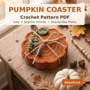 May include: A stack of orange crochet pumpkin coasters tied with twine, featuring a small green leaf and stem detail. The text reads PUMPKIN COASTER Crochet Pattern PDF Easy Beginner Friendly Step-by-Step Photos and ShynPrint.