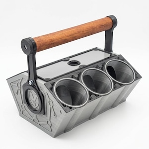 May include: A gray, angular storage caddy featuring three circular compartments and a rectangular tray section. It includes a wooden handle supported by black brackets on each side. The side panel displays a circular emblem with the text V6.
