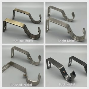 May include: Four pairs of curtain rod brackets in antique brass, bright nickel, brushed nickel, and black nickel finishes. Each bracket has a curved hook and a flat mounting plate. Text labels each finish.