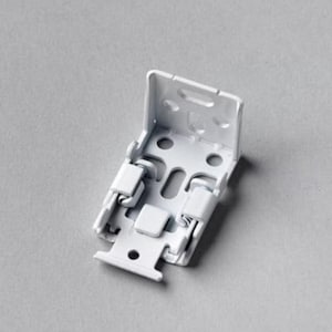 May include: A white metal blind bracket with a rectangular backplate and multiple holes. The bracket has two hinged arms and a small, rectangular base. The object is designed to hold blinds and is shown against a grey background.