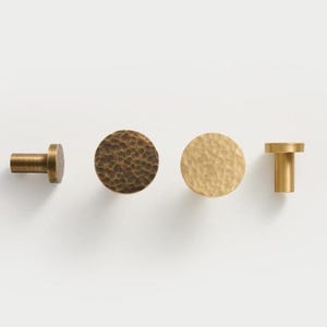 May include: A set of three ceramic mugs with a speckled, matte finish. Each mug features a different color: light blue, cream, and gray. The mugs have a simple, modern design and a comfortable handle.