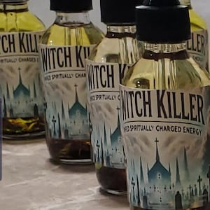 May include: Several glass bottles with black droppers, filled with a yellow liquid and dark sediment. Each bottle has a label with the words "Witch Killer" and a gothic church illustration. The text reads "Infused Spiritually Charged Energy."