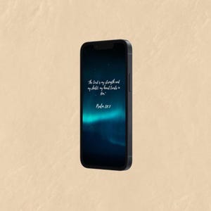 May include: A black smartphone displaying a dark blue and teal background with white text. The text reads "The Lord is my strength and my shield: my heart trusts in Him." and "Psalm 28:7."