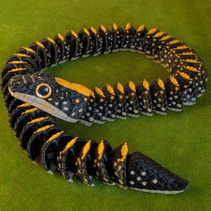 May include: A segmented, articulated snake figurine featuring a black body with yellow dorsal ridges and white spots. The head has large, prominent eyes and a textured scale pattern. The body is composed of multiple interlocking pieces.