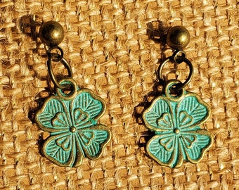 Brincos de Trevo: Brincos de pino em formato de trevo de quatro folhas com esmalte verde, sem níquel e acabamento em metal bronzeado com efeito dourado antigo.