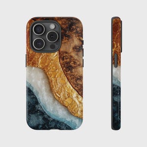 May include: A phone case with a unique design. The case features a combination of materials and colors, including gold, brown, white, and dark blue. The design has a layered effect, with the colors and textures blending together to create a visually appealing look.