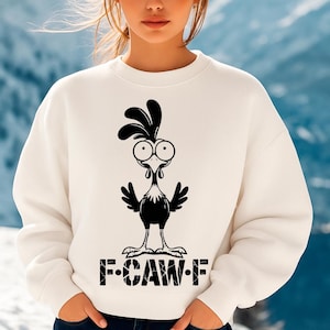 May include: A white sweatshirt featuring a black cartoon rooster design with large eyes and the text "F-CAW-F" at the bottom. The rooster has a crest and wings. The sweatshirt is a casual style.