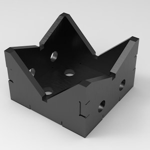 May include: A black, geometric, angular container with a crown-like shape. The container has a square base and angled sides with circular holes. The design is modern and minimalist, suitable for various uses.