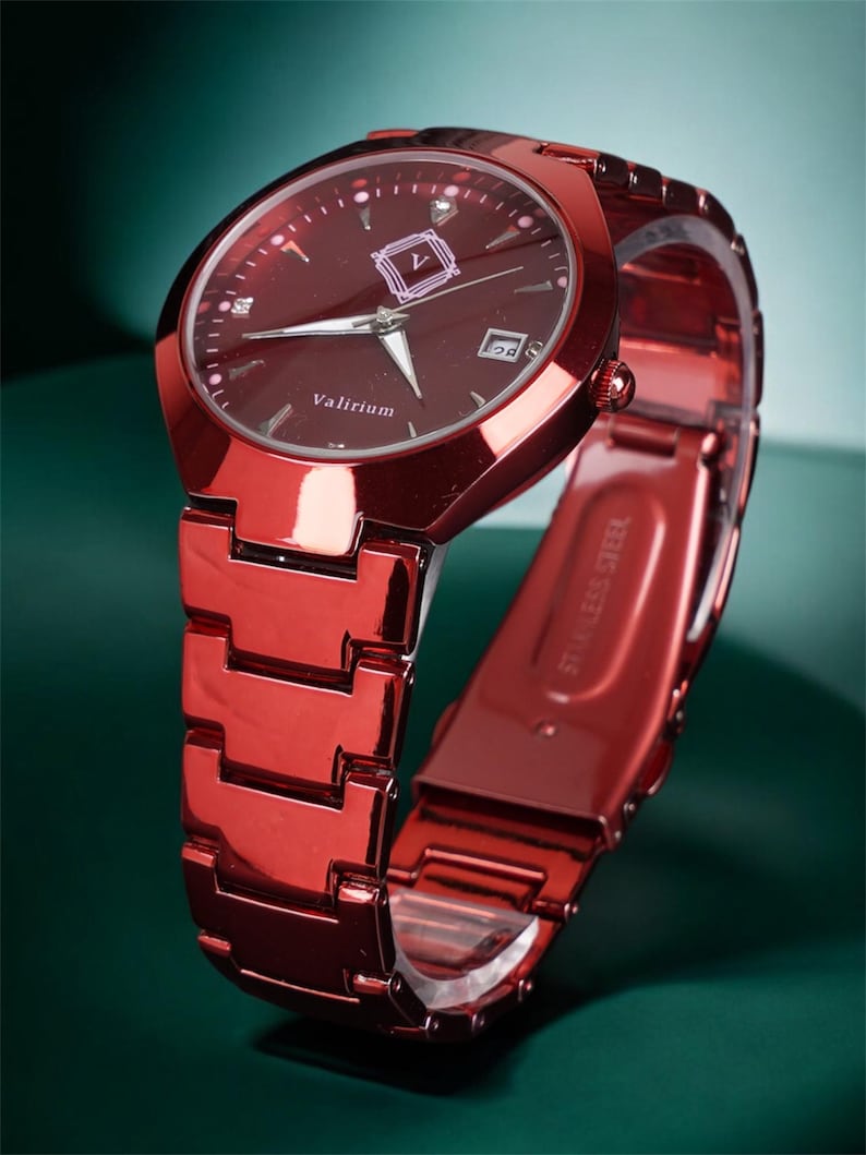 May include: A red wristwatch with a matching strap. The watch face is a deep red with silver hands and markers. The brand name "Valirium" is printed on the watch face. The strap is made of linked metal pieces.