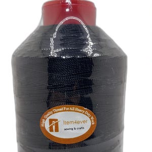 May include: A large spool of black sewing thread wrapped in clear plastic, featuring a circular label with the text Item4ever sewing & crafts. Beside it is a color chart displaying various thread shades and a collection of assorted thread spools.