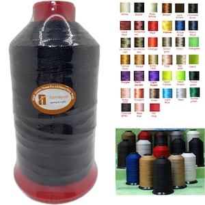May include: A large spool of black sewing thread wrapped in clear plastic, featuring a circular label with the text Item4ever sewing & crafts. Beside it is a color chart displaying various thread shades and a collection of assorted thread spools.