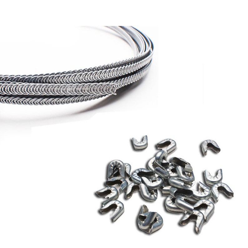 May include: A coil of silver-colored chainmail, a type of woven metal armor, and a pile of silver-colored metal rings. The rings are used to create chainmail.